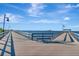 Wooden pier offers beautiful waterfront views, a bench for relaxing, and the skyline of the distant city at 1206 2Nd E Ave, Bradenton, FL 34208