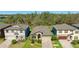 An aerial view of a well-maintained single-story home with lush landscaping and a paved driveway at 12750 Oak Hill Way, Parrish, FL 34219