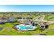 Aerial perspective of a pool and clubhouse, enhanced by surrounding homes and greenery, exemplifying community at 12750 Oak Hill Way, Parrish, FL 34219