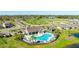 Aerial view highlighting the pool and clubhouse amenities, nestled within a well-maintained community landscape at 12750 Oak Hill Way, Parrish, FL 34219