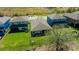 A view of the home's backyard and green lawn, featuring a partial fence and views of a wooded area at 12750 Oak Hill Way, Parrish, FL 34219