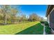 Spacious backyard with a lush lawn and secure black wrought iron fencing at 12750 Oak Hill Way, Parrish, FL 34219