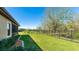 Expansive backyard featuring manicured landscaping and sturdy black wrought iron fencing at 12750 Oak Hill Way, Parrish, FL 34219