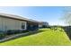 Lush backyard featuring a covered patio and secure black metal fencing, ideal for outdoor living at 12750 Oak Hill Way, Parrish, FL 34219