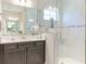 Elegant bathroom featuring sleek vanity with marble top and glass-enclosed shower at 12750 Oak Hill Way, Parrish, FL 34219