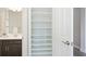 Bathroom linen closet offering ample storage solutions next to the vanity at 12750 Oak Hill Way, Parrish, FL 34219