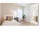 Inviting bedroom with a neutral color scheme, bright window and ensuite bathroom access at 12750 Oak Hill Way, Parrish, FL 34219