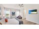 Serene bedroom with hardwood floors, comfortable seating, and large windows at 12750 Oak Hill Way, Parrish, FL 34219