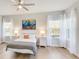 Bright bedroom featuring hardwood floors, a comfortable bed, and scenic views at 12750 Oak Hill Way, Parrish, FL 34219