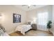 Cozy bedroom featuring neutral tones, a plush bed, and natural light from the window at 12750 Oak Hill Way, Parrish, FL 34219
