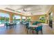 Spacious community space with tables and chairs, designed for outdoor gatherings, set by the community pool at 12750 Oak Hill Way, Parrish, FL 34219