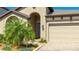 Close up of a charming single-story home featuring manicured landscaping and an attached two-car garage at 12750 Oak Hill Way, Parrish, FL 34219