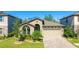 Charming single-story home featuring a well-manicured lawn, a two-car garage, and beautiful landscaping at 12750 Oak Hill Way, Parrish, FL 34219