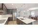 Bright kitchen featuring stainless steel appliances, a center island with seating, and pendant lighting at 12750 Oak Hill Way, Parrish, FL 34219