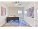 Well-lit home office with neutral walls, unique sports decor, and comfortable workspace at 12750 Oak Hill Way, Parrish, FL 34219