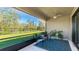 Screened in lanai featuring a ceiling fan and a view of the lush backyard at 12750 Oak Hill Way, Parrish, FL 34219