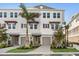 Beautiful new construction townhomes showcase a light gray exterior, complemented by lush landscaping and a private garage at 1620 Sea Haven Dr # 408, Punta Gorda, FL 33950