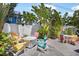 Tropical backyard with colorful Adirondack chairs surrounding a modern square gas fire pit at 2211 Avenue C, Bradenton Beach, FL 34217