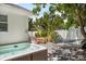 Private backyard with a hot tub, hammock, and outdoor dining area at 2211 Avenue C, Bradenton Beach, FL 34217