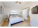 Coastal bedroom featuring a king bed, shiplap accent wall, and barn door to bathroom at 2211 Avenue C, Bradenton Beach, FL 34217