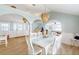Elegant dining room with a large white table, stylish lighting, and views into the living spaces at 2211 Avenue C, Bradenton Beach, FL 34217