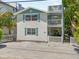 Charming two-story home with a white picket fence and multiple balconies at 2211 Avenue C, Bradenton Beach, FL 34217