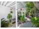 Landscaped front yard showcasing lush tropical foliage and a welcoming walkway to the front door at 2211 Avenue C, Bradenton Beach, FL 34217