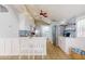 Bright kitchen features white cabinets, stainless steel appliances, and a breakfast bar area at 2211 Avenue C, Bradenton Beach, FL 34217