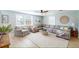 Comfortable living room with a large sectional sofa, light wood floors, and bright, coastal decor at 2211 Avenue C, Bradenton Beach, FL 34217