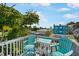 Relaxing rooftop deck with Adirondack chairs and pleasant neighborhood views at 2211 Avenue C, Bradenton Beach, FL 34217