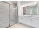 Luxurious bathroom showcasing a glass-enclosed shower with marble-style tile and double vanity at 26908 Victoria Pl, Punta Gorda, FL 33955