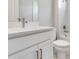 Clean bathroom featuring a white vanity with a quartz countertop, toilet, and bathtub-shower combo with a white tile surround at 26908 Victoria Pl, Punta Gorda, FL 33955