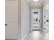 Bright foyer features wood look tile flooring, neutral paint, and an exterior door with windows at 26908 Victoria Pl, Punta Gorda, FL 33955