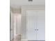Bright hallway featuring white doors, neutral paint, and light wood-look floors adding style and functionality at 26908 Victoria Pl, Punta Gorda, FL 33955