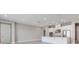Bright, open-concept kitchen featuring white cabinets, stainless steel appliances, and a spacious center island at 26908 Victoria Pl, Punta Gorda, FL 33955