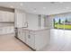 Bright kitchen with a large island, stainless steel appliances, and a view to the outside at 26908 Victoria Pl, Punta Gorda, FL 33955