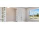 Bright and airy office space featuring french doors and natural light from the window overlooking green space at 26908 Victoria Pl, Punta Gorda, FL 33955