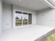 Rear covered patio with plenty of space for entertaining, and featuring a large sliding glass door at 26908 Victoria Pl, Punta Gorda, FL 33955