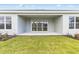 An inviting covered patio offers a serene outdoor space and seamless transition to the grassy lawn, perfect for relaxing or entertaining at 26908 Victoria Pl, Punta Gorda, FL 33955