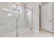 Modern shower with glass enclosure and tile surround, plus adjacent toilet and doorway at 26908 Victoria Pl, Punta Gorda, FL 33955
