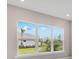 Sunny window view of backyard landscaping and blue skies at 26908 Victoria Pl, Punta Gorda, FL 33955