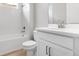 Bright bathroom featuring a tub, shower, and modern vanity with white cabinets at 26930 Lark Ct, Punta Gorda, FL 33955