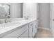 Bright bathroom featuring double sink vanity with white cabinets, modern fixtures, and wood flooring at 26930 Lark Ct, Punta Gorda, FL 33955