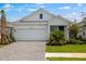 Charming single-Gathering home featuring a two-car garage, lush green lawn, and well-maintained landscaping at 26930 Lark Ct, Punta Gorda, FL 33955