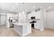 Modern kitchen featuring stainless steel appliances, white cabinets, a large island, and beautiful wood flooring at 26930 Lark Ct, Punta Gorda, FL 33955