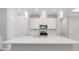 Modern kitchen featuring white cabinets, quartz countertops, stainless steel appliances, and pendant lighting at 26930 Lark Ct, Punta Gorda, FL 33955
