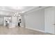 Spacious living area with elegant lighting, neutral palette, and wood floors, connecting to a modern kitchen at 26930 Lark Ct, Punta Gorda, FL 33955