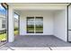 Covered patio with stone pavers overlooking green backyard at 26930 Lark Ct, Punta Gorda, FL 33955