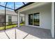 Covered patio with stone pavers overlooking green backyard at 26930 Lark Ct, Punta Gorda, FL 33955