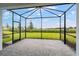 Screened-in patio with stone pavers and a view of the green backyard at 26930 Lark Ct, Punta Gorda, FL 33955